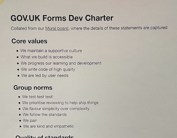 The GOV.UK Forms Dev Charter printed out and stuck to a board