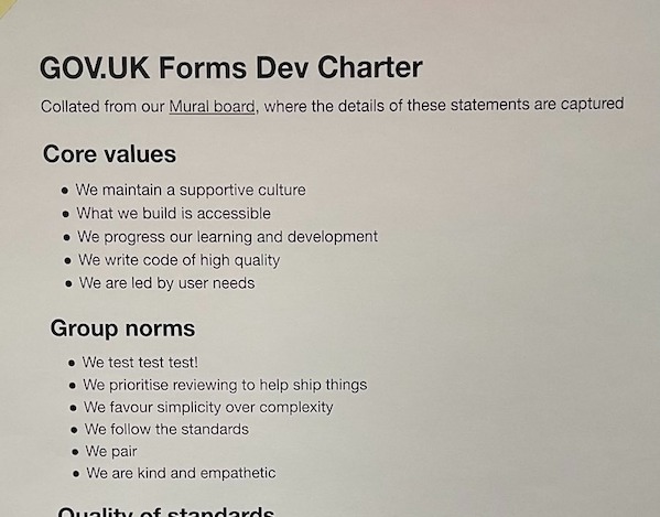 The GOV.UK Forms Dev Charter printed out and stuck to a board
